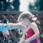 two children playing with water